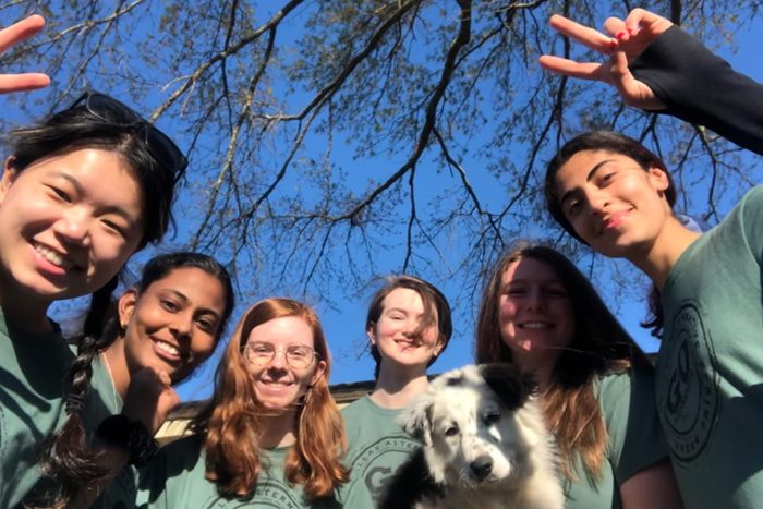 A group of Alternative Spring Break participants and a dog.